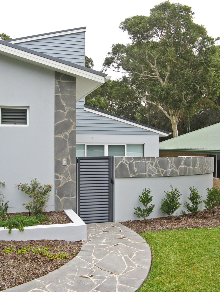 Photo of a mid-sized contemporary two-storey blue exterior in Sydney.