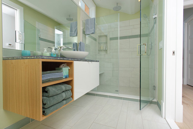 This is an example of a beach style 3/4 bathroom in Philadelphia with flat-panel cabinets, white cabinets, white tile, porcelain tile, an undermount tub, an alcove shower, a vessel sink, green walls and porcelain floors.