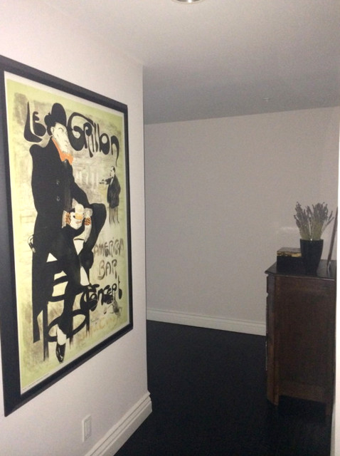 Example of a mid-sized minimalist dark wood floor hallway design in Los Angeles with white walls