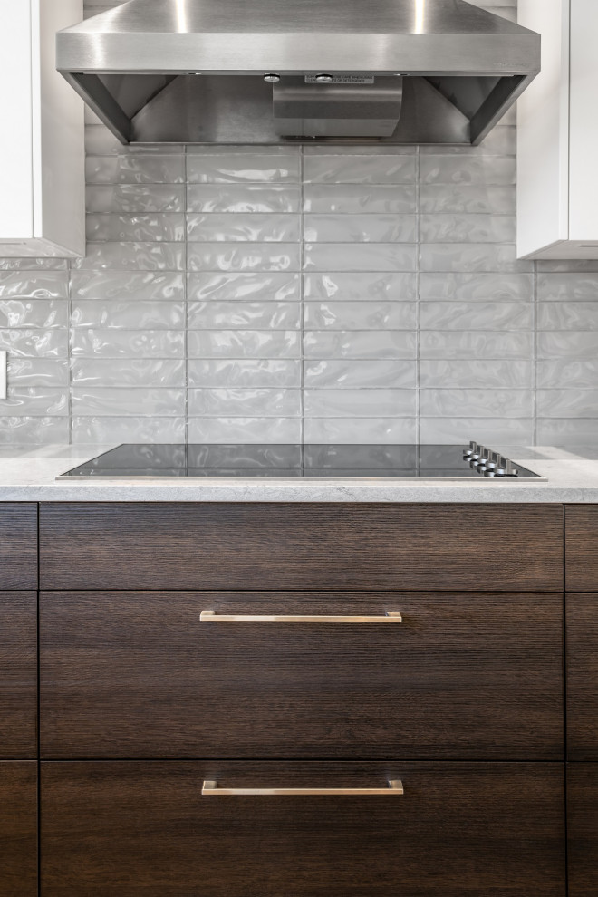 Example of a mid-sized transitional l-shaped light wood floor and brown floor eat-in kitchen design in Calgary with an undermount sink, shaker cabinets, dark wood cabinets, quartzite countertops, gray backsplash, ceramic backsplash, stainless steel appliances, an island and beige countertops