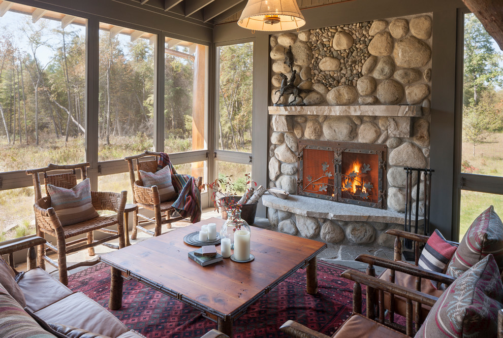 Inspiration for a huge rustic screened-in porch remodel in Grand Rapids with a roof extension