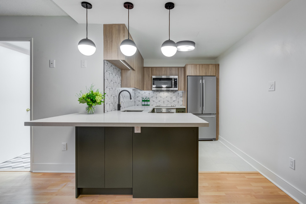 Design ideas for a small country u-shaped kitchen in Toronto with an undermount sink, flat-panel cabinets, light wood cabinets, quartz benchtops, multi-coloured splashback, porcelain splashback, stainless steel appliances, porcelain floors, with island, grey floor and white benchtop.