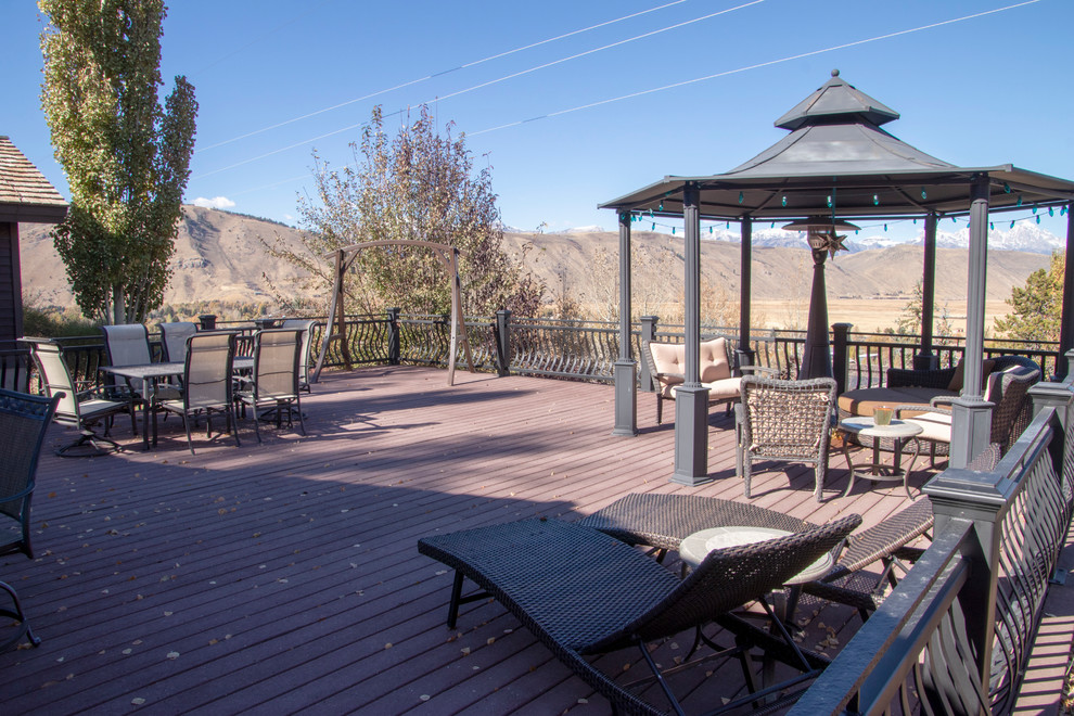 Inspiration for a large rustic backyard deck remodel with no cover