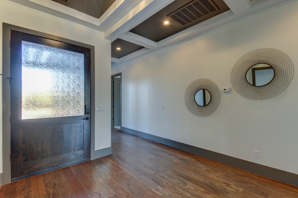 Mid-sized transitional dark wood floor and brown floor foyer photo in Phoenix with white walls and a dark wood front door