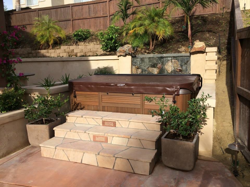Photo of a large transitional backyard partial sun garden in San Diego with a water feature and brick pavers.