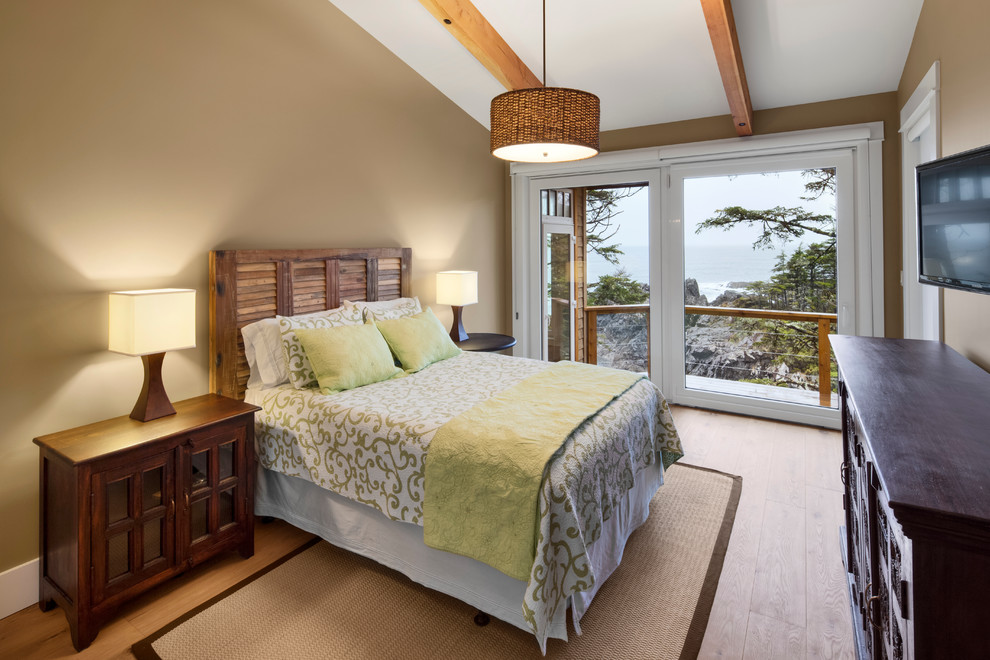 Inspiration for a transitional bedroom in Vancouver with beige walls and medium hardwood floors.