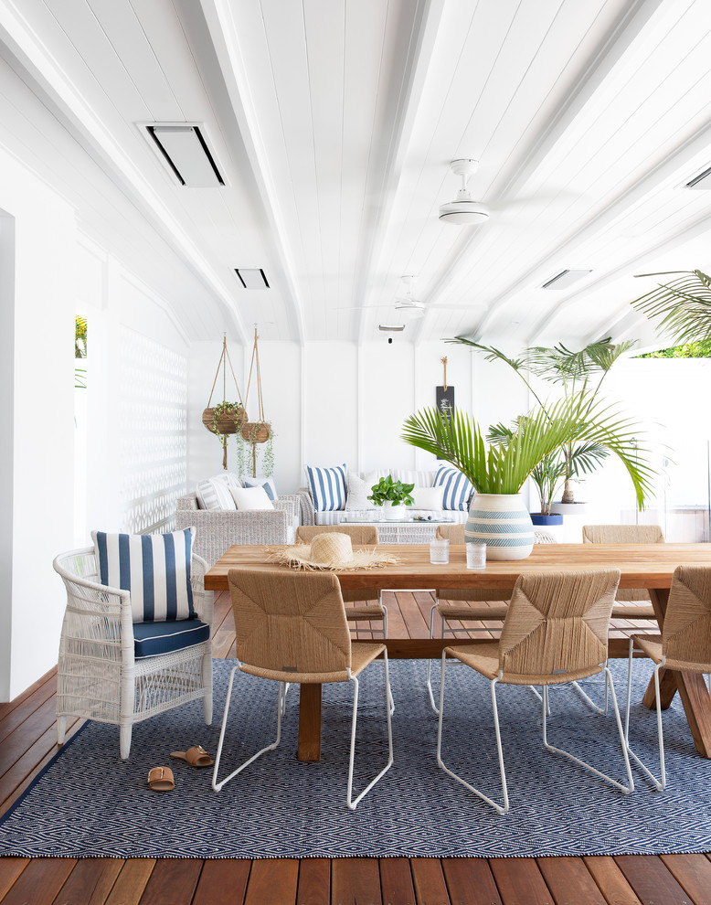 Design ideas for a large beach style backyard patio in Gold Coast - Tweed with decking and a roof extension.