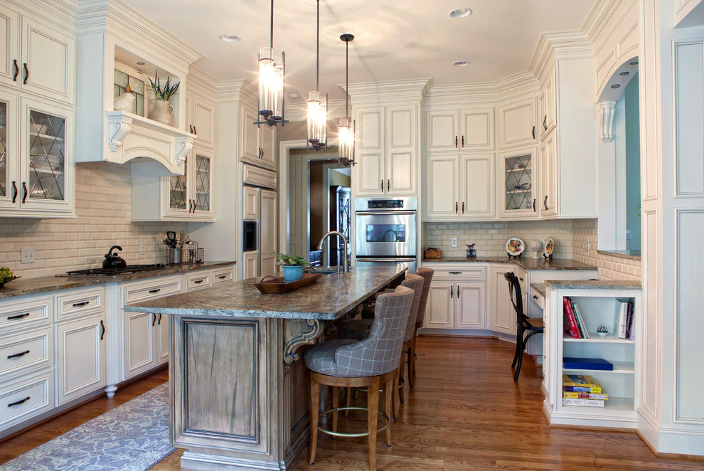 Traditional kitchen in Charlotte with recessed-panel cabinets, beige cabinets, white splashback and stainless steel appliances.