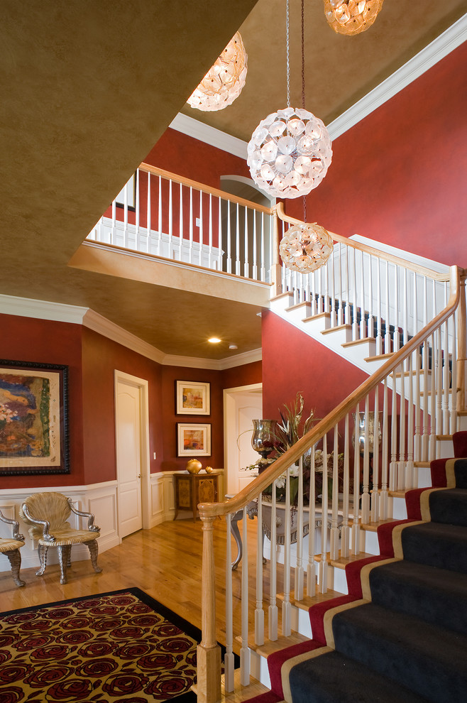 Foyer - large transitional light wood floor foyer idea with red walls