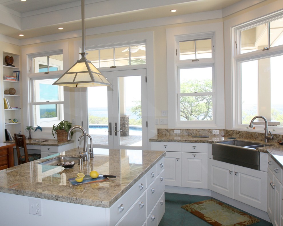 Design ideas for a large beach style kitchen in San Diego with a farmhouse sink, raised-panel cabinets, white cabinets, granite benchtops, blue splashback, glass tile splashback, stainless steel appliances, concrete floors, multiple islands, turquoise floor and multi-coloured benchtop.