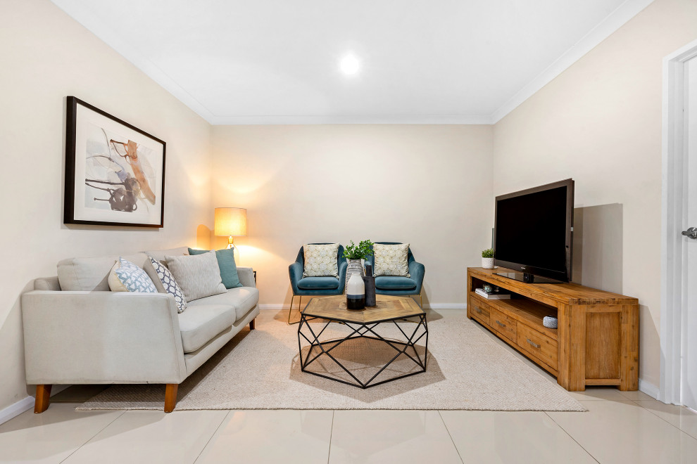 Photo of a medium sized contemporary open plan games room in Sydney with white walls, ceramic flooring, a freestanding tv and beige floors.