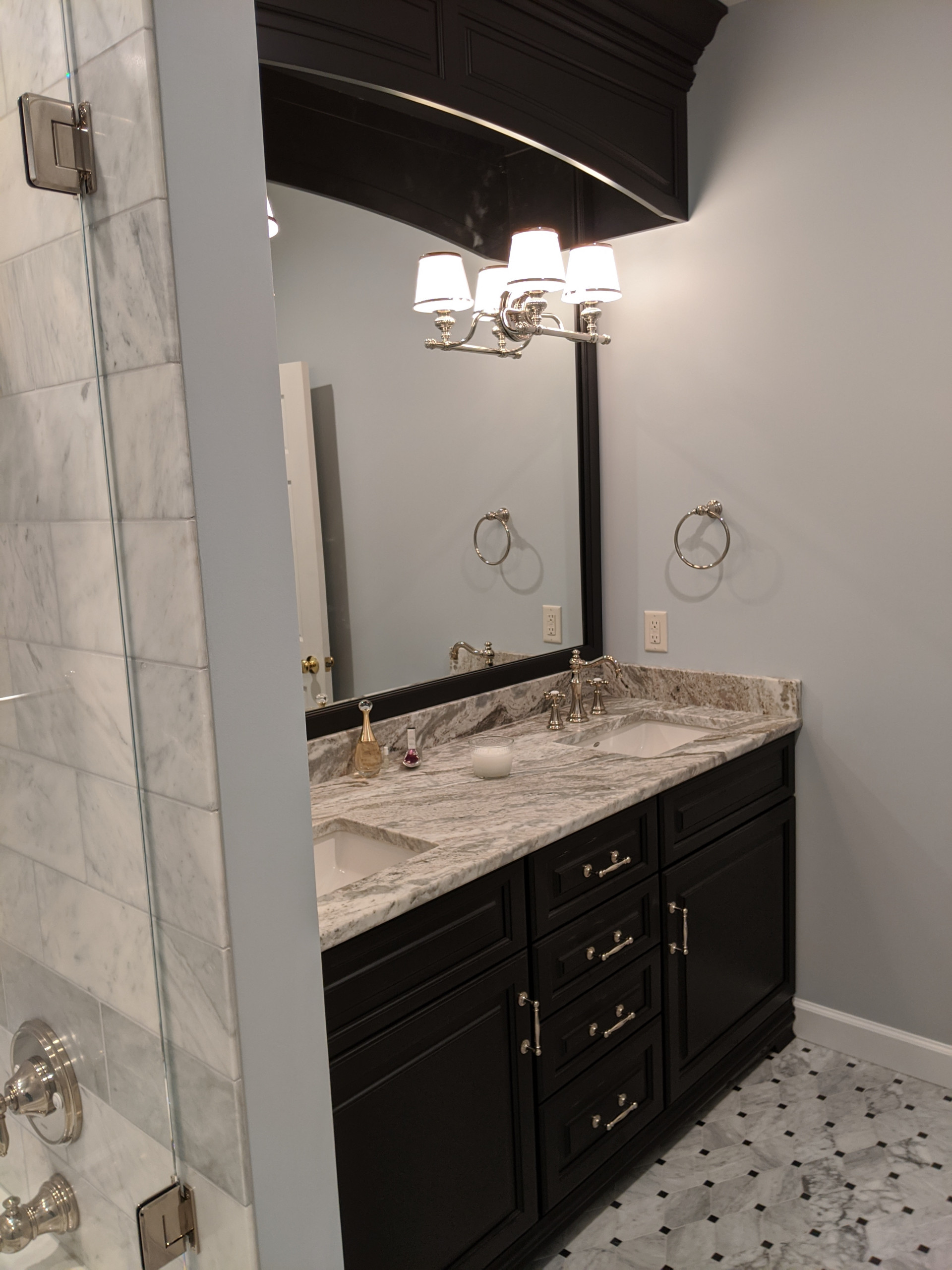 Mid-sized elegant marble tile marble floor and double-sink bathroom photo in Other with furniture-like cabinets, black cabinets, a two-piece toilet, gray walls, an undermount sink, marble countertops,