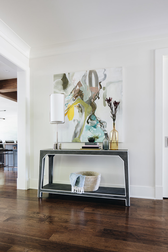Inspiration for a large transitional dark wood floor and brown floor foyer remodel in Chicago with white walls and a black front door