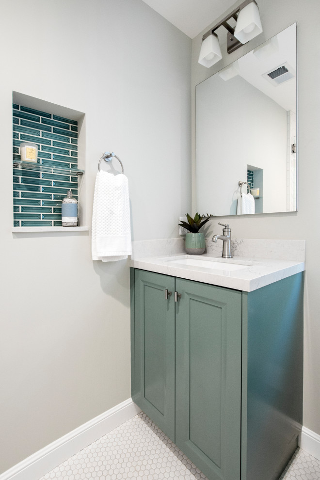 Inspiration for a medium sized classic cloakroom in San Francisco with recessed-panel cabinets, green cabinets, a one-piece toilet, white tiles, porcelain tiles, beige walls, mosaic tile flooring, a submerged sink, engineered stone worktops, white floors, white worktops and a built in vanity unit.
