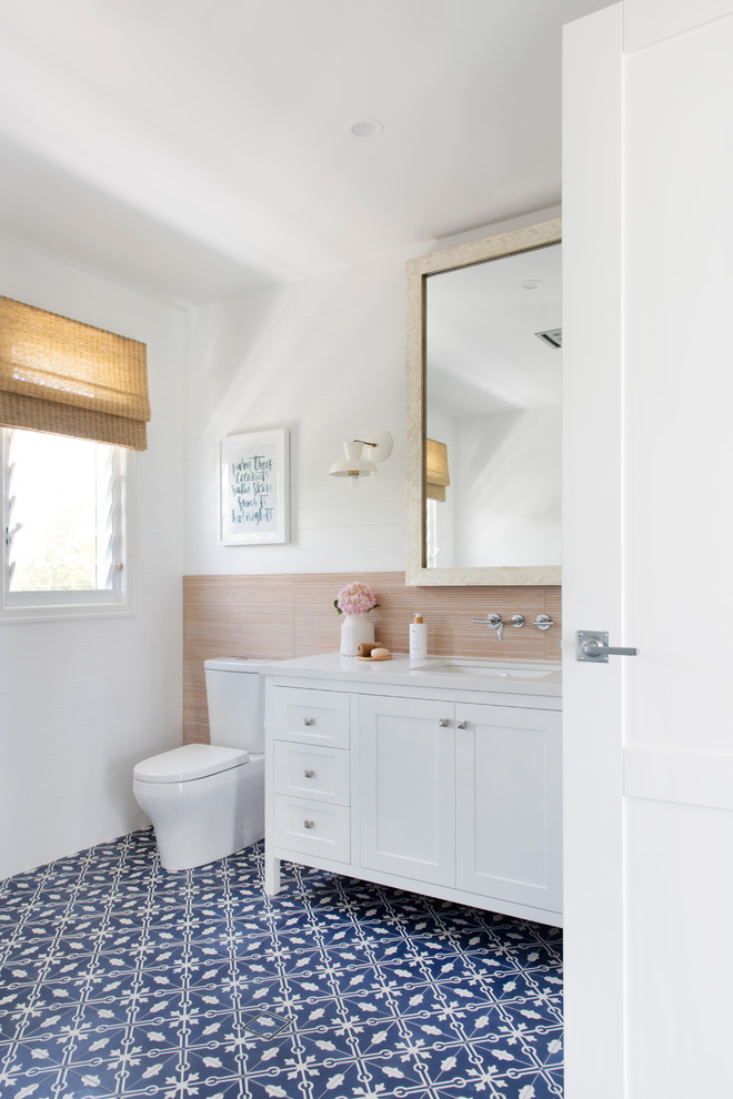 Photo of a large beach style bathroom in Gold Coast - Tweed with white cabinets, white walls, an undermount sink, blue floor, white benchtops, shaker cabinets, a freestanding tub, a corner shower, a wall-mount toilet, gray tile, porcelain tile, cement tiles, engineered quartz benchtops and a hinged shower door.