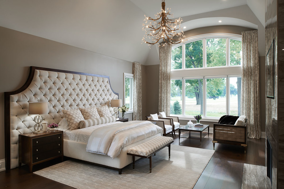 Expansive contemporary master bedroom in Detroit with beige walls, dark hardwood floors, a two-sided fireplace, a tile fireplace surround and brown floor.