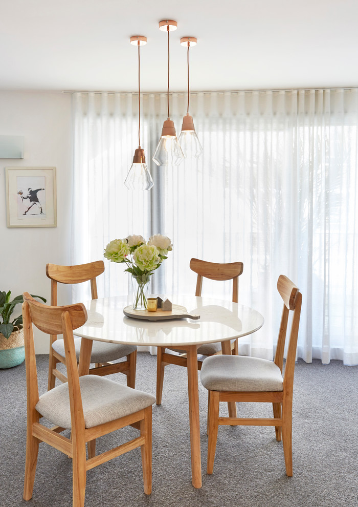 This is an example of a contemporary dining room in Sydney.