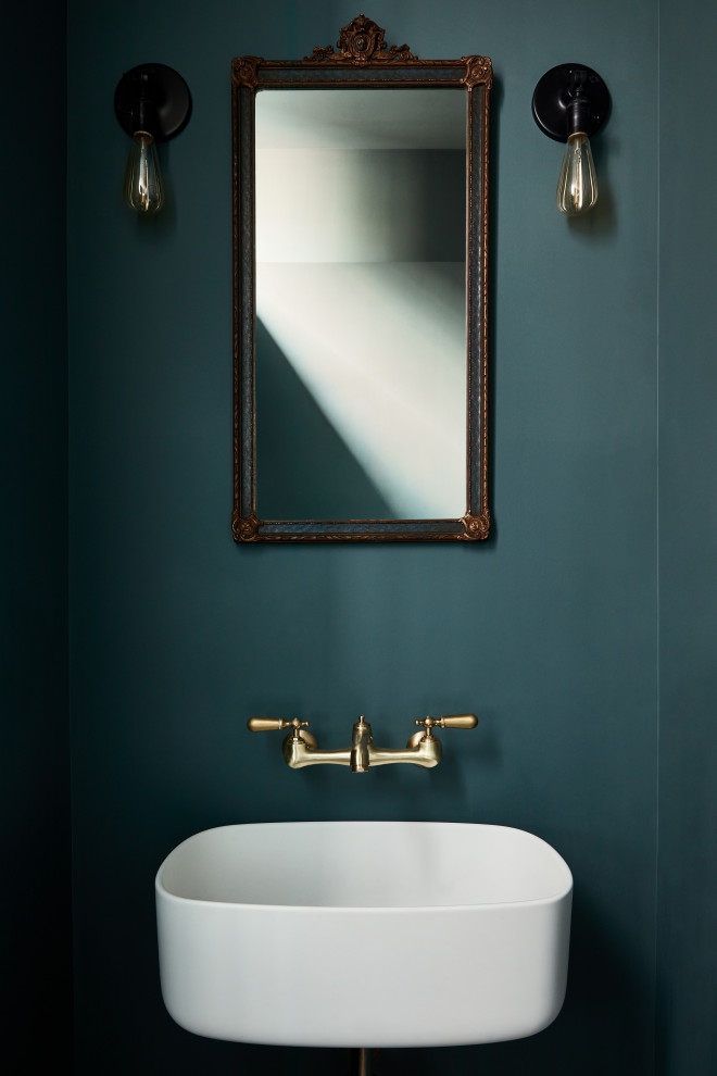 Design ideas for a modern powder room in New York with green walls and a wall-mount sink.