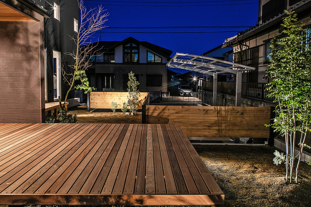 Design ideas for a contemporary side yard deck in Other with a roof extension.