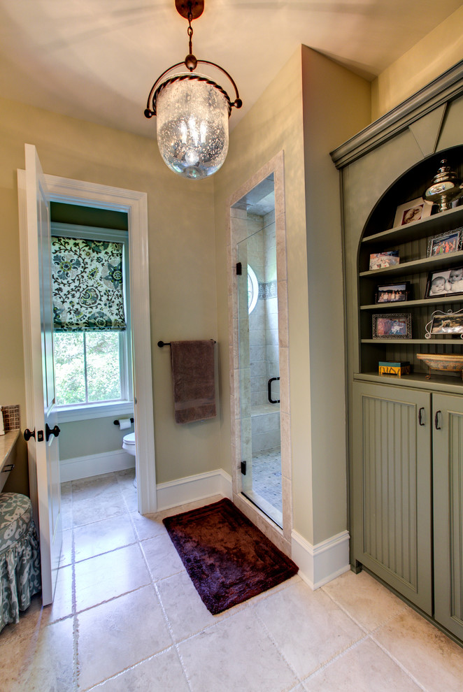 Photo of a mid-sized transitional 3/4 bathroom in Charleston with grey cabinets, an alcove shower, a two-piece toilet, beige tile, ceramic tile, beige walls, ceramic floors, granite benchtops, a freestanding tub, a vessel sink and recessed-panel cabinets.
