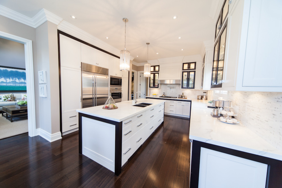 Mid-sized transitional l-shaped dark wood floor and brown floor kitchen photo in Toronto with an undermount sink, shaker cabinets, white cabinets, quartz countertops, multicolored backsplash, quartz backsplash, stainless steel appliances, an island and multicolored countertops