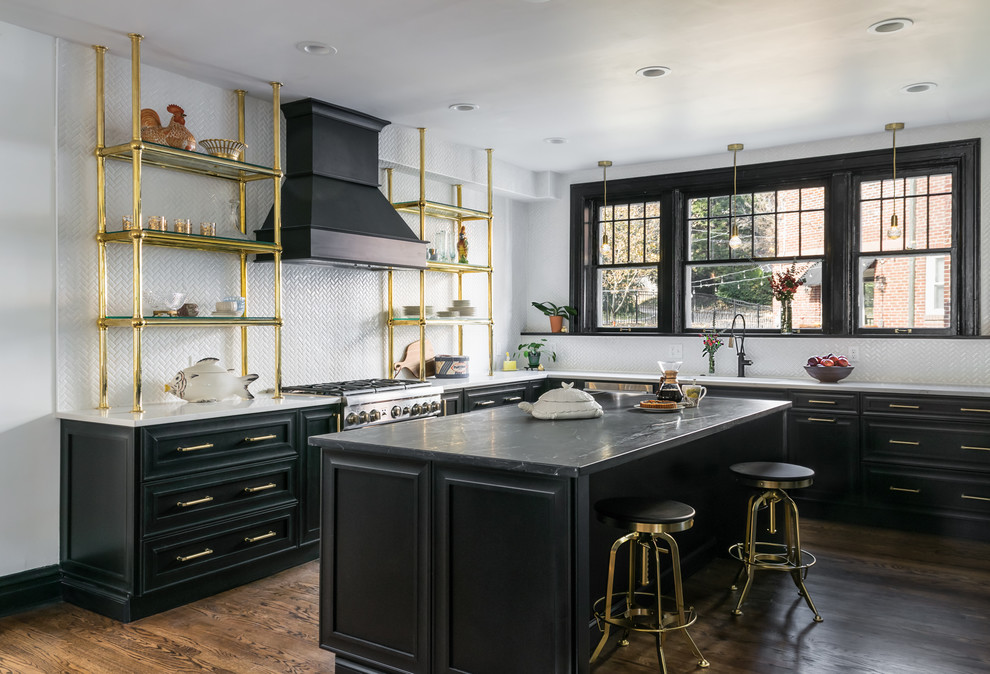Large traditional l-shaped kitchen in St Louis with soapstone benchtops, white splashback, ceramic splashback, stainless steel appliances, with island, brown floor, grey benchtop, dark hardwood floors and raised-panel cabinets.