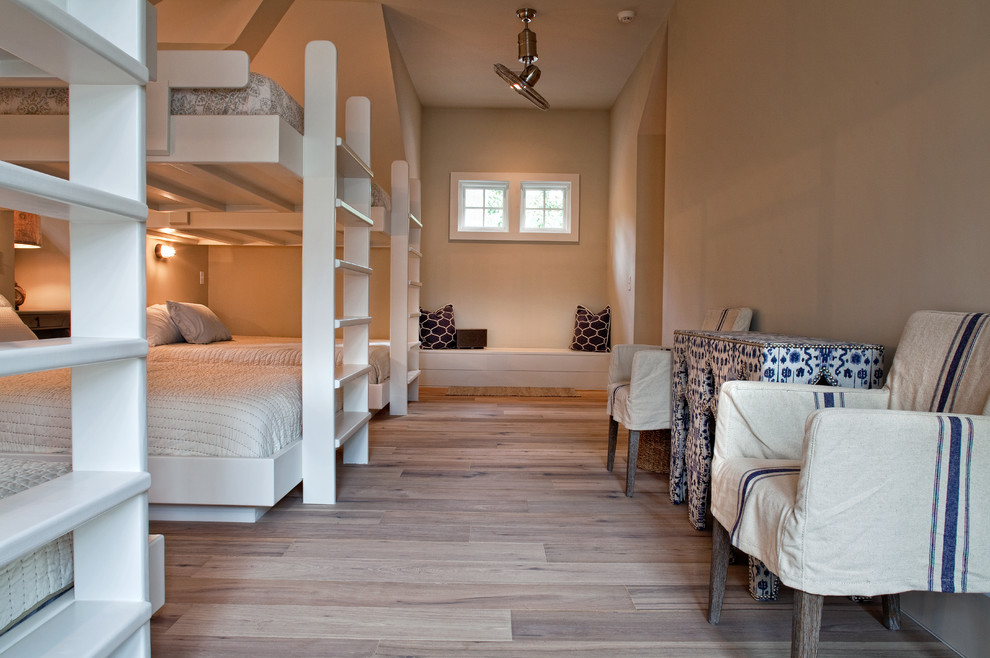 This is an example of a large beach style gender-neutral kids' room for kids 4-10 years old in Charleston with medium hardwood floors and brown floor.