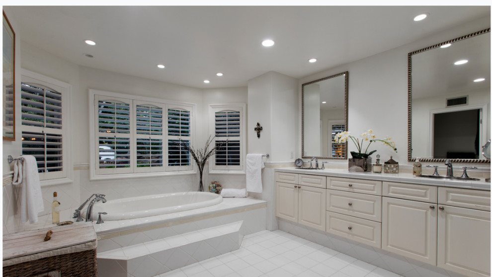 Design ideas for a mid-sized contemporary master bathroom in Orange County with flat-panel cabinets, white cabinets, beige tile, subway tile, tile benchtops, grey benchtops, a double vanity and a built-in vanity.