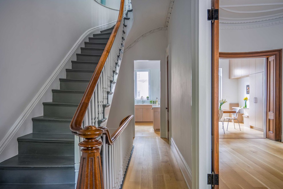 Photo of a mid-sized traditional wood l-shaped staircase in Boston with wood risers and wood railing.