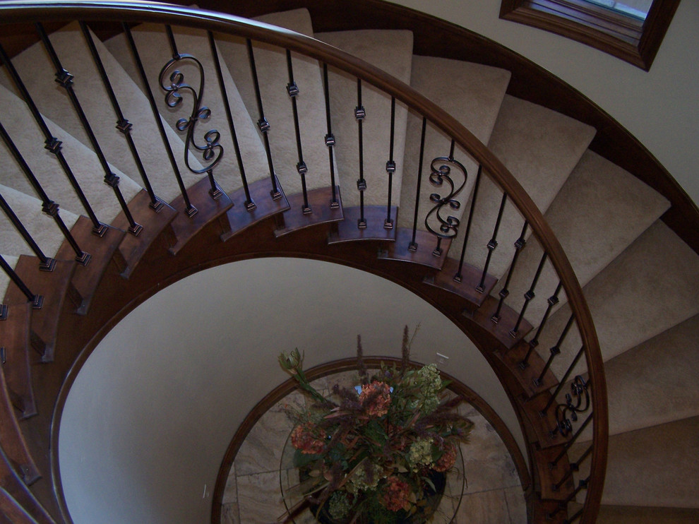 Example of a large classic carpeted curved staircase design in Salt Lake City with carpeted risers
