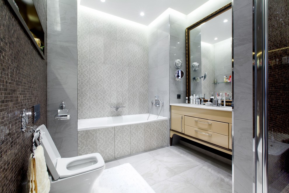 Inspiration for a contemporary master bathroom in Moscow with flat-panel cabinets, an alcove tub, an alcove shower, a one-piece toilet, gray tile, white walls and light wood cabinets.