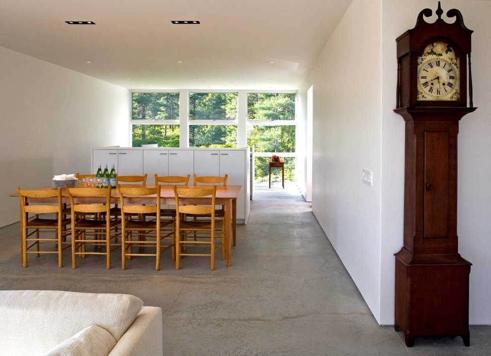 Inspiration for a modern dining room in Other with concrete floors.