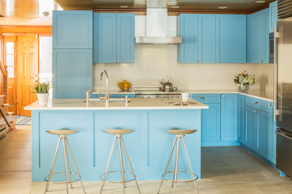 Design ideas for a transitional l-shaped kitchen in Portland Maine with shaker cabinets, blue cabinets, quartz benchtops, stainless steel appliances, with island, an undermount sink and beige splashback.