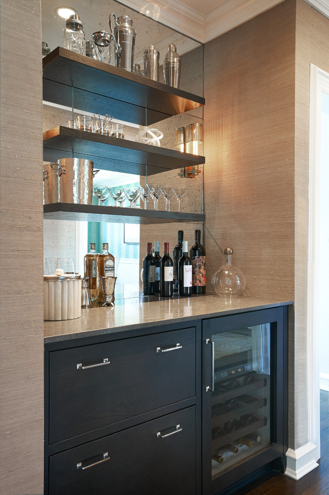 Inspiration for a large country l-shaped home bar in New York with an undermount sink, shaker cabinets, grey cabinets, quartzite benchtops, grey splashback, stone slab splashback and dark hardwood floors.