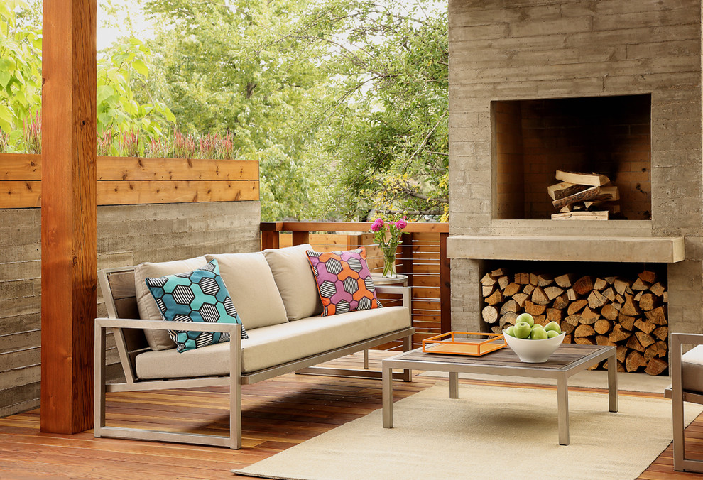 Contemporary backyard deck in Denver with a fire feature and a pergola.
