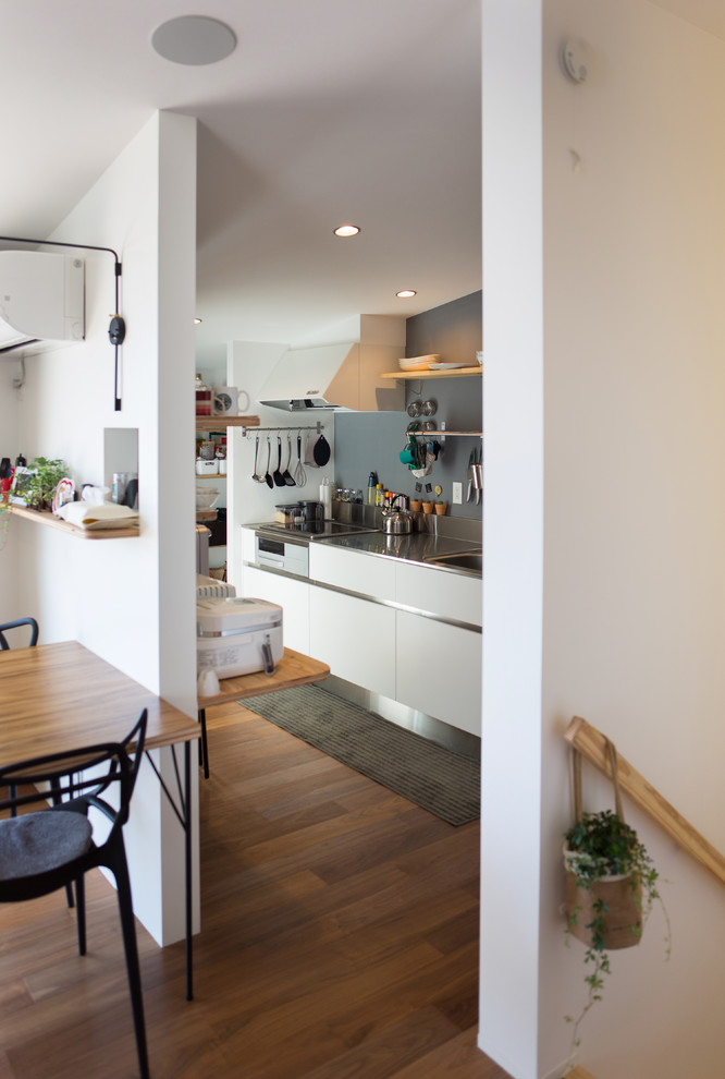Inspiration for a small modern dark wood floor kitchen pantry remodel with gray cabinets and wood countertops