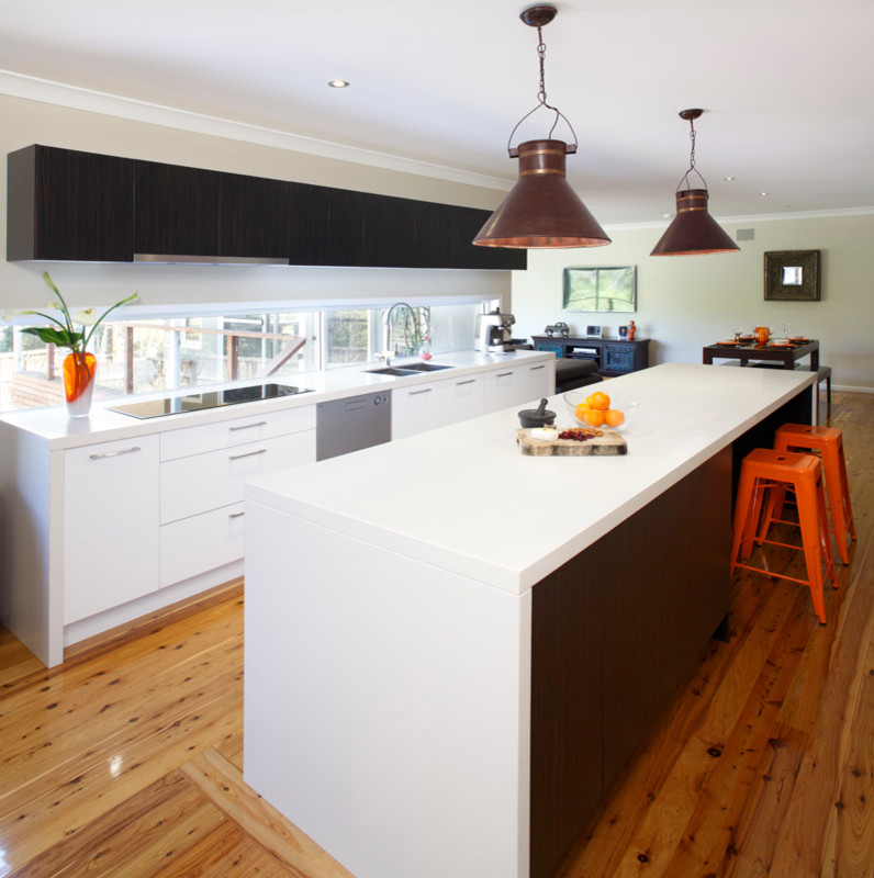 Inspiration for a large contemporary l-shaped separate kitchen in Sydney with a double-bowl sink, flat-panel cabinets, white cabinets, quartz benchtops, window splashback, stainless steel appliances, light hardwood floors and with island.