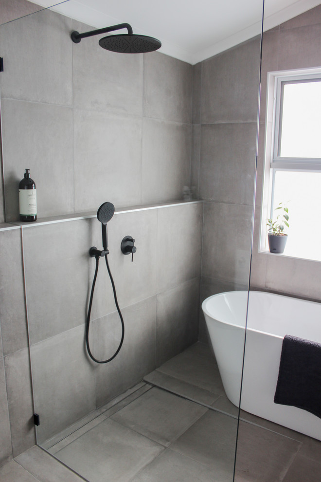 Large modern master wet room bathroom in Perth with flat-panel cabinets, white cabinets, a freestanding tub, a one-piece toilet, gray tile, porcelain tile, grey walls, porcelain floors, a vessel sink, engineered quartz benchtops, grey floor, an open shower and grey benchtops.