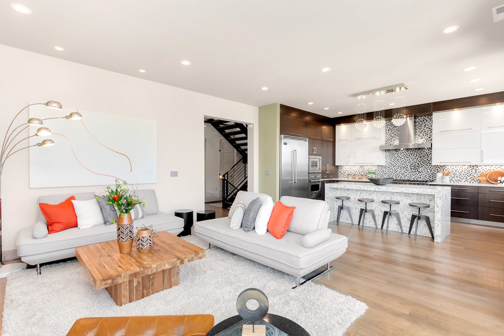 Family room - large modern open concept light wood floor family room idea in Seattle with a standard fireplace, a metal fireplace and beige walls