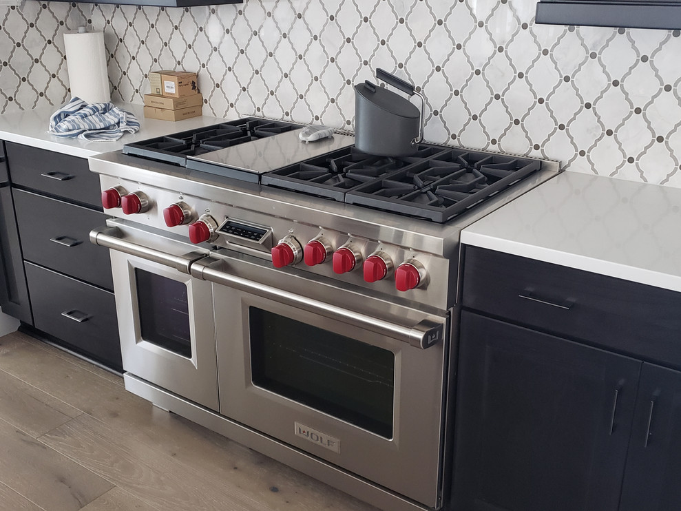 Inspiration for a huge transitional porcelain tile eat-in kitchen remodel in Phoenix with an undermount sink, shaker cabinets, dark wood cabinets, quartz countertops, multicolored backsplash, mosaic tile backsplash, stainless steel appliances, an island and white countertops