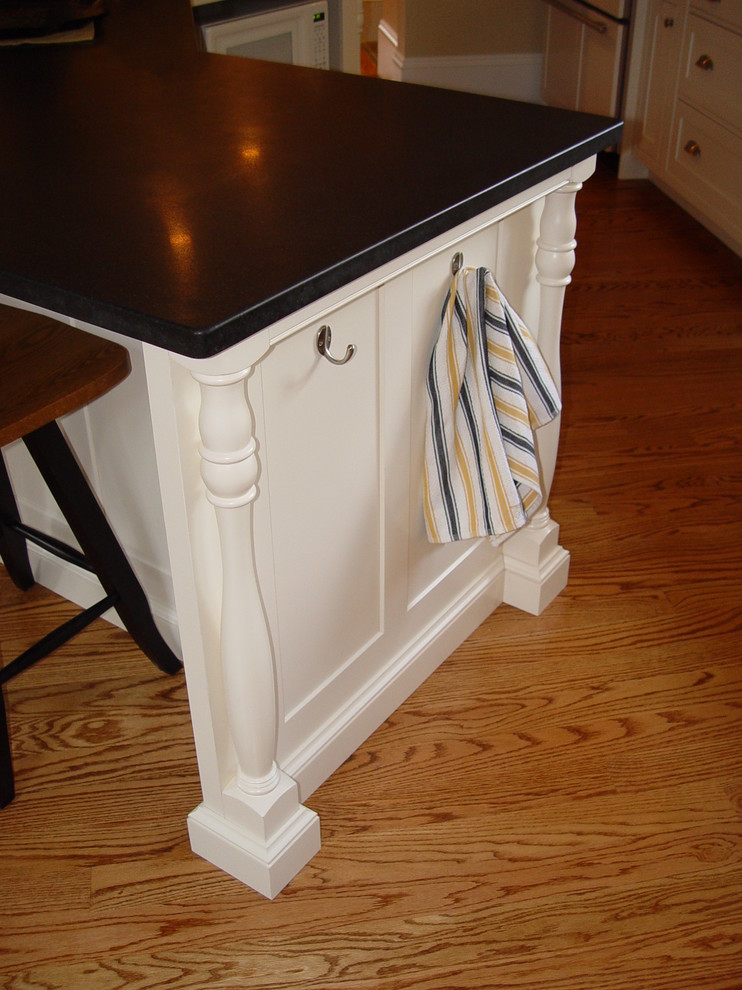 Eat-in kitchen - transitional medium tone wood floor eat-in kitchen idea in Boston with an undermount sink, beaded inset cabinets, white cabinets, granite countertops, white backsplash, subway tile backsplash, paneled appliances, yellow walls and an island