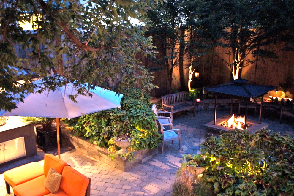 Mid-sized arts and crafts backyard shaded garden in Chicago with a fire feature and concrete pavers for spring.