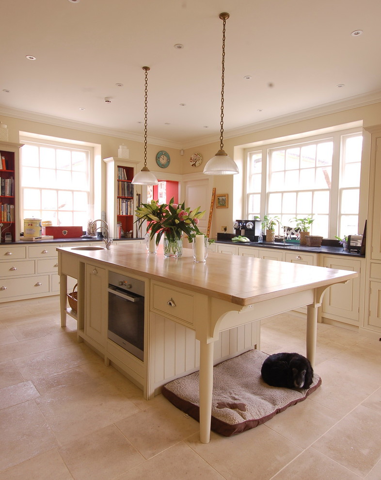 Design ideas for a country u-shaped kitchen in Wiltshire with an undermount sink, beige cabinets and with island.