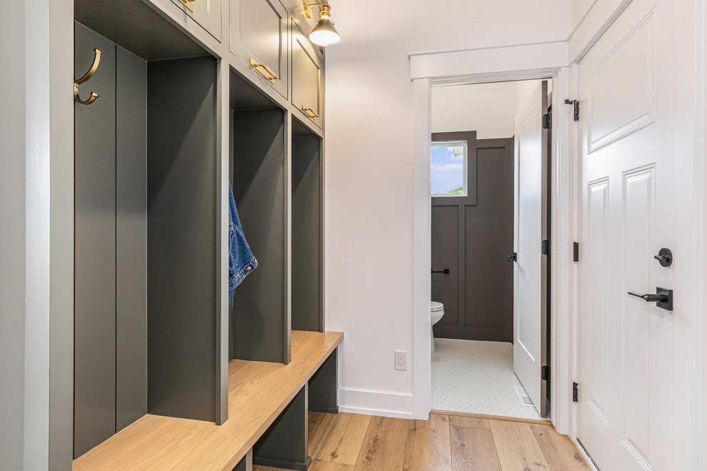 Entryway - transitional vinyl floor, beige floor and shiplap wall entryway idea in Grand Rapids with white walls and a black front door