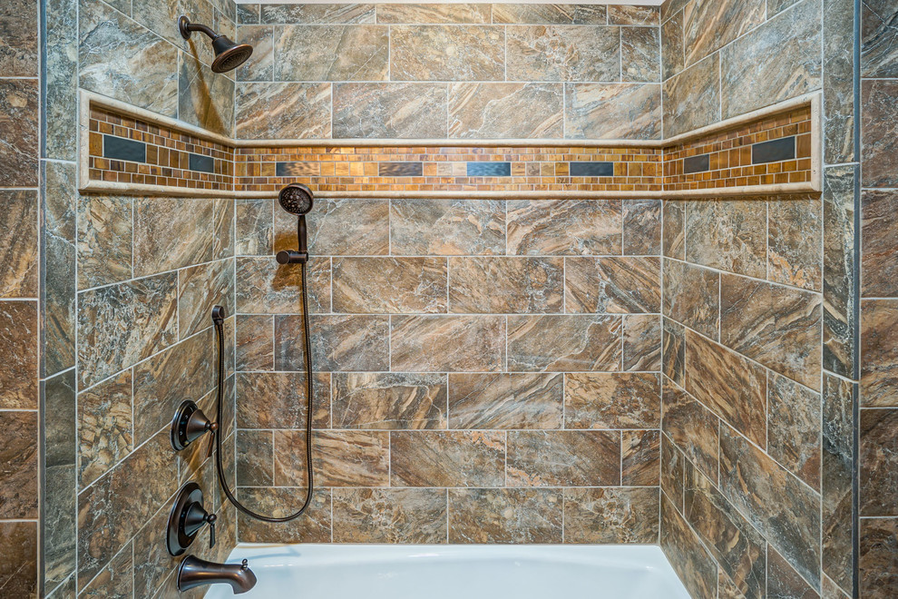 This is an example of a mid-sized 3/4 bathroom in Albuquerque with raised-panel cabinets, dark wood cabinets, an alcove tub, a shower/bathtub combo, a two-piece toilet, beige tile, brown tile, ceramic tile, beige walls, ceramic floors, an undermount sink, granite benchtops and beige floor.