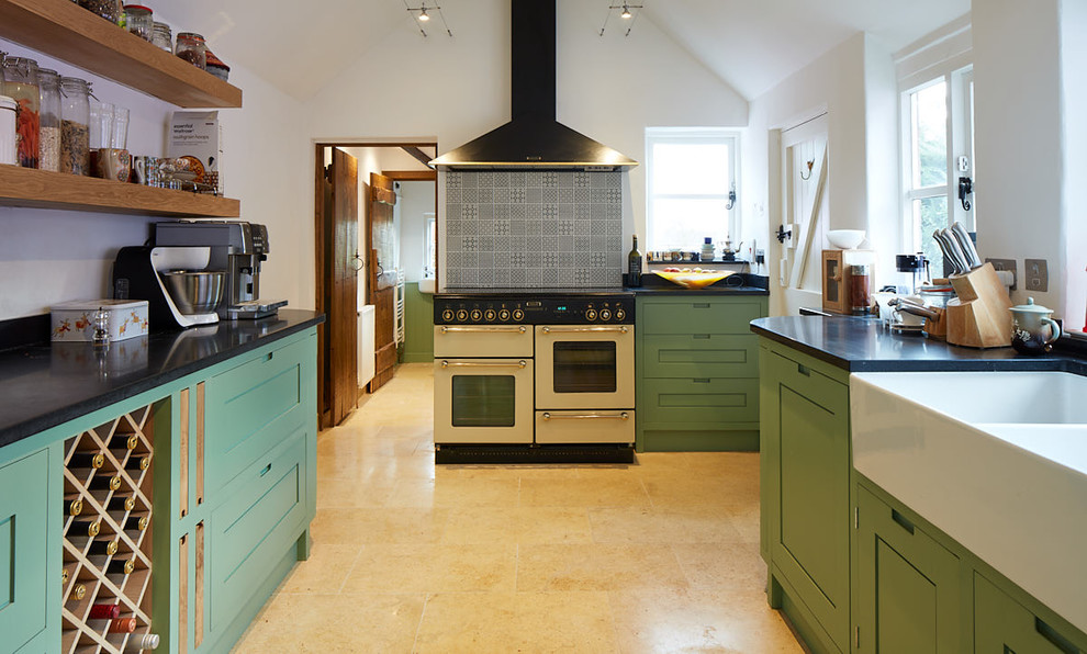 Photo of a transitional u-shaped kitchen in Other with a farmhouse sink, shaker cabinets, green cabinets, grey splashback, white appliances, beige floor and black benchtop.
