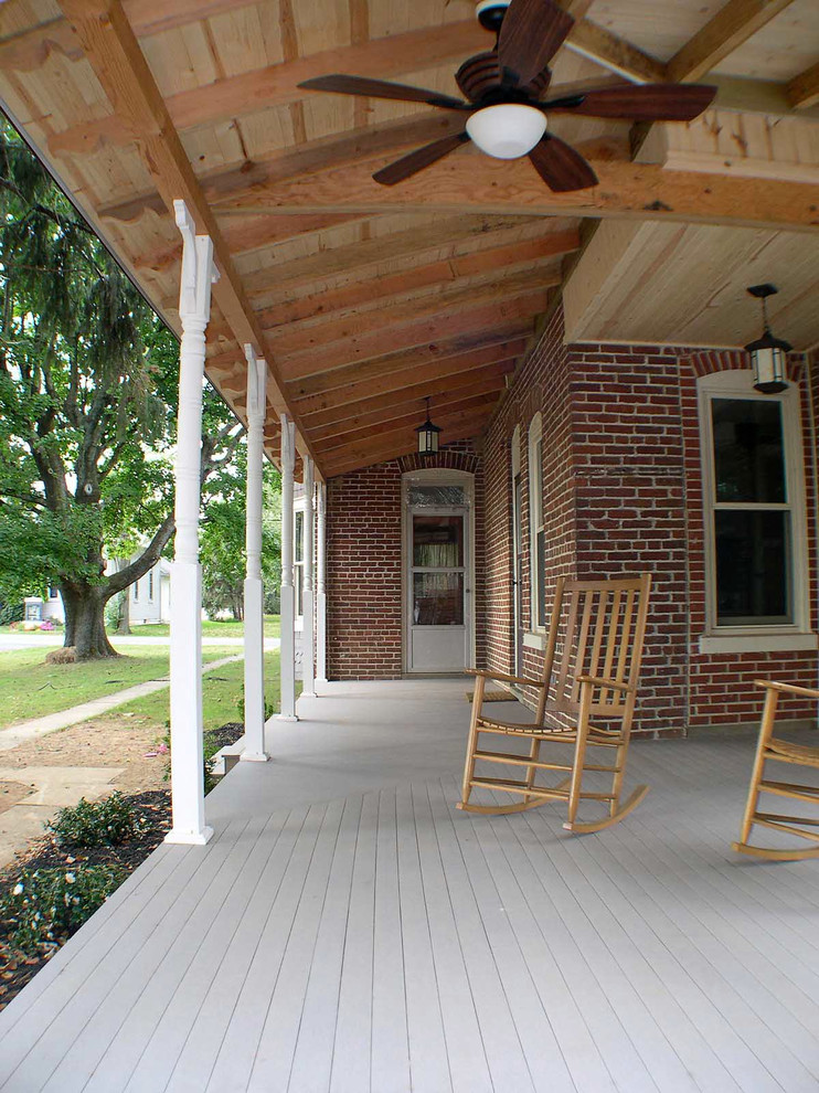 This is an example of a mid-sized traditional side yard verandah in Philadelphia with a roof extension.