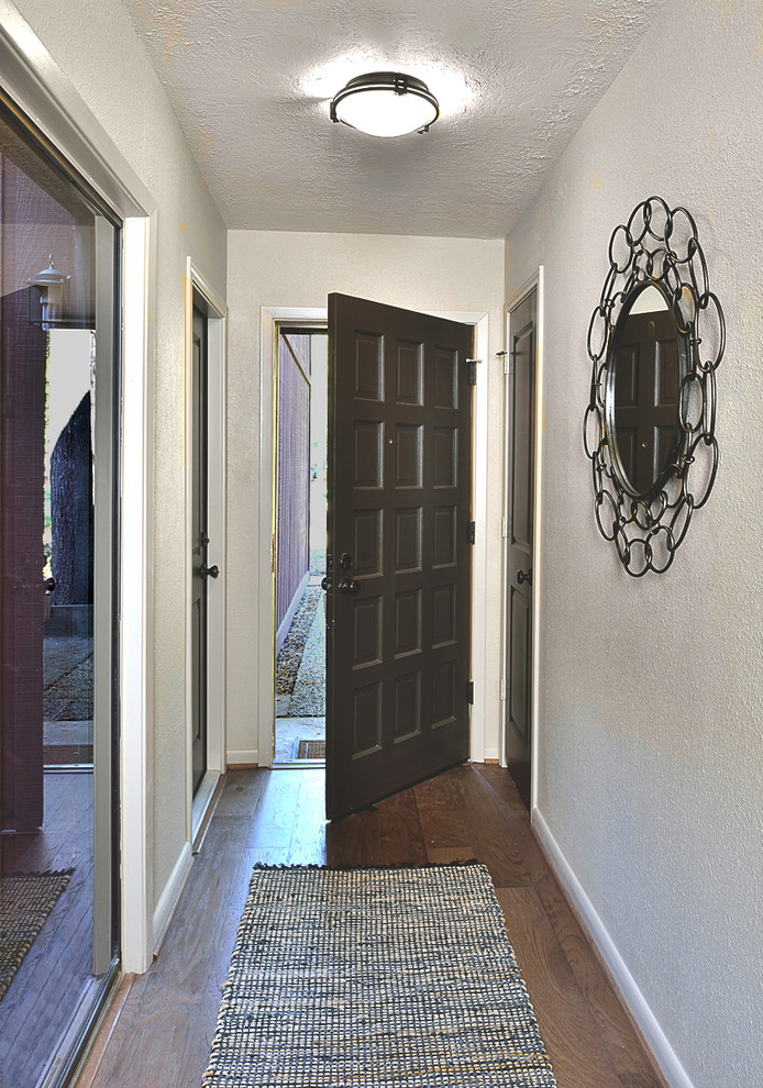 Inspiration for a small transitional foyer in Houston with beige walls and medium hardwood floors.