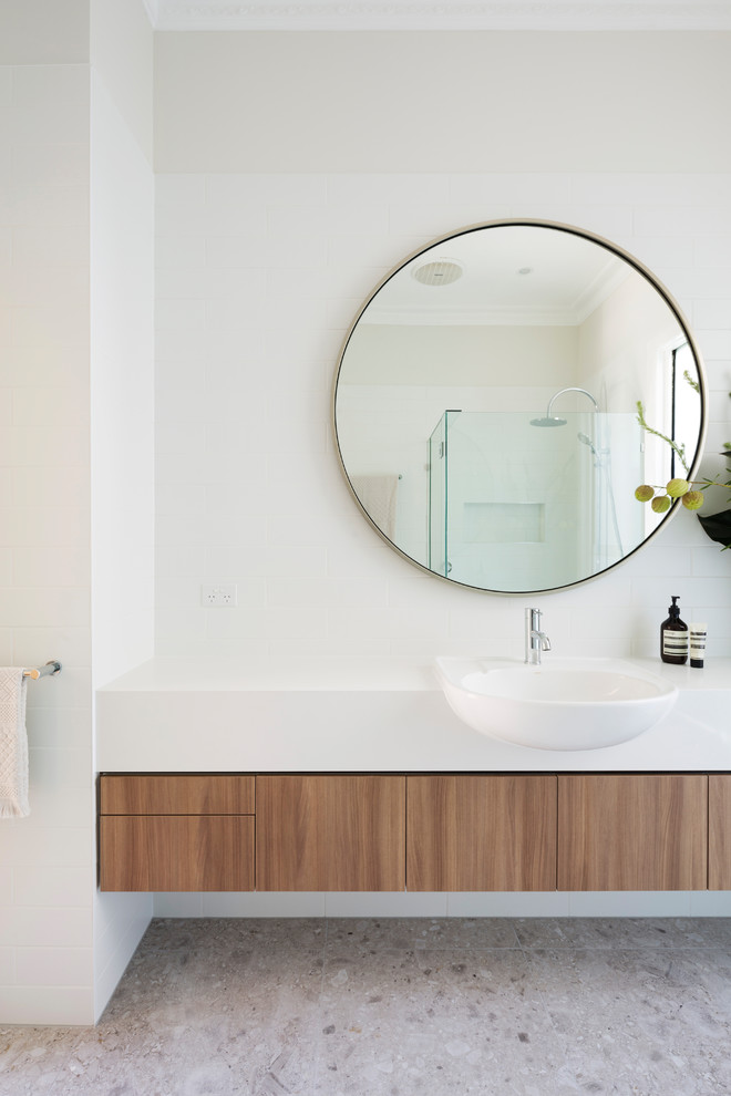 Design ideas for a mid-sized contemporary 3/4 bathroom in Melbourne with medium wood cabinets, white tile, porcelain tile, white walls, porcelain floors, engineered quartz benchtops, beige floor, a hinged shower door and white benchtops.