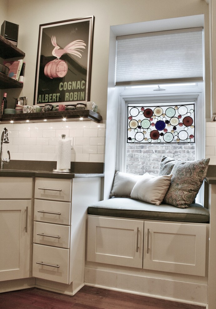 Inspiration for a large transitional u-shaped light wood floor and brown floor enclosed kitchen remodel in Chicago with an undermount sink, shaker cabinets, white cabinets, quartz countertops, white backsplash, subway tile backsplash, stainless steel appliances and no island